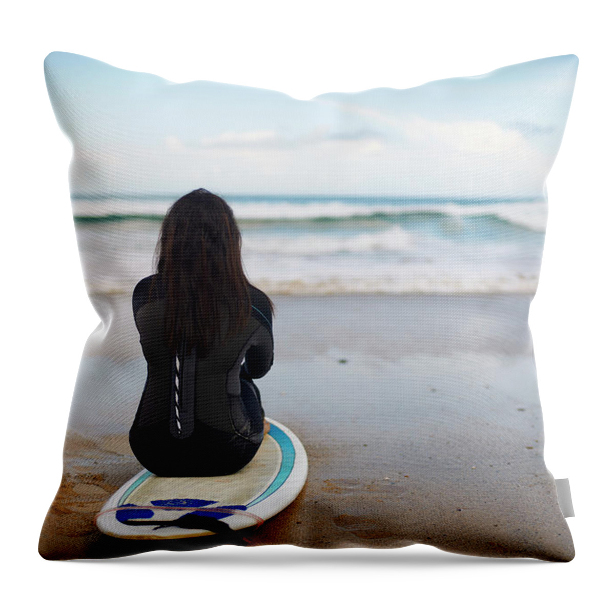 Tranquility Throw Pillow featuring the photograph Surfer Sitting On Board On Beach by Peter Muller