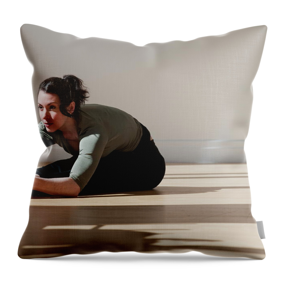 Ballet Dancer Throw Pillow featuring the photograph Woman Performing Stretching Exercise by Tetra Images