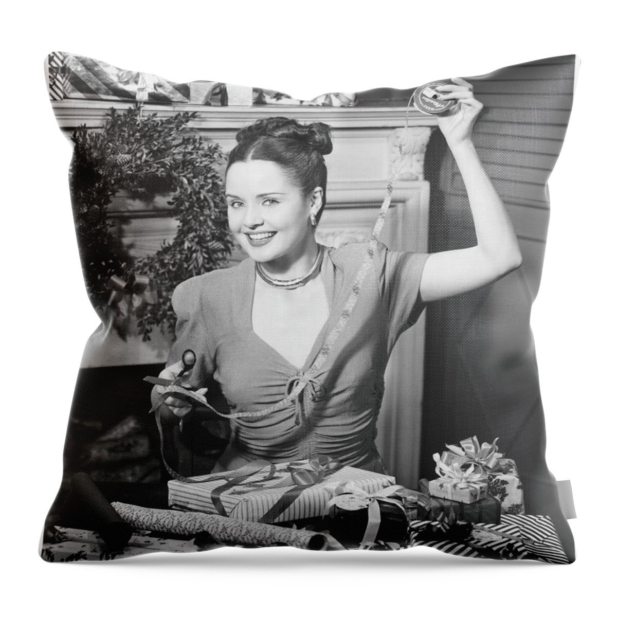 Human Arm Throw Pillow featuring the photograph Woman Wrapping Christmas Presents In by George Marks