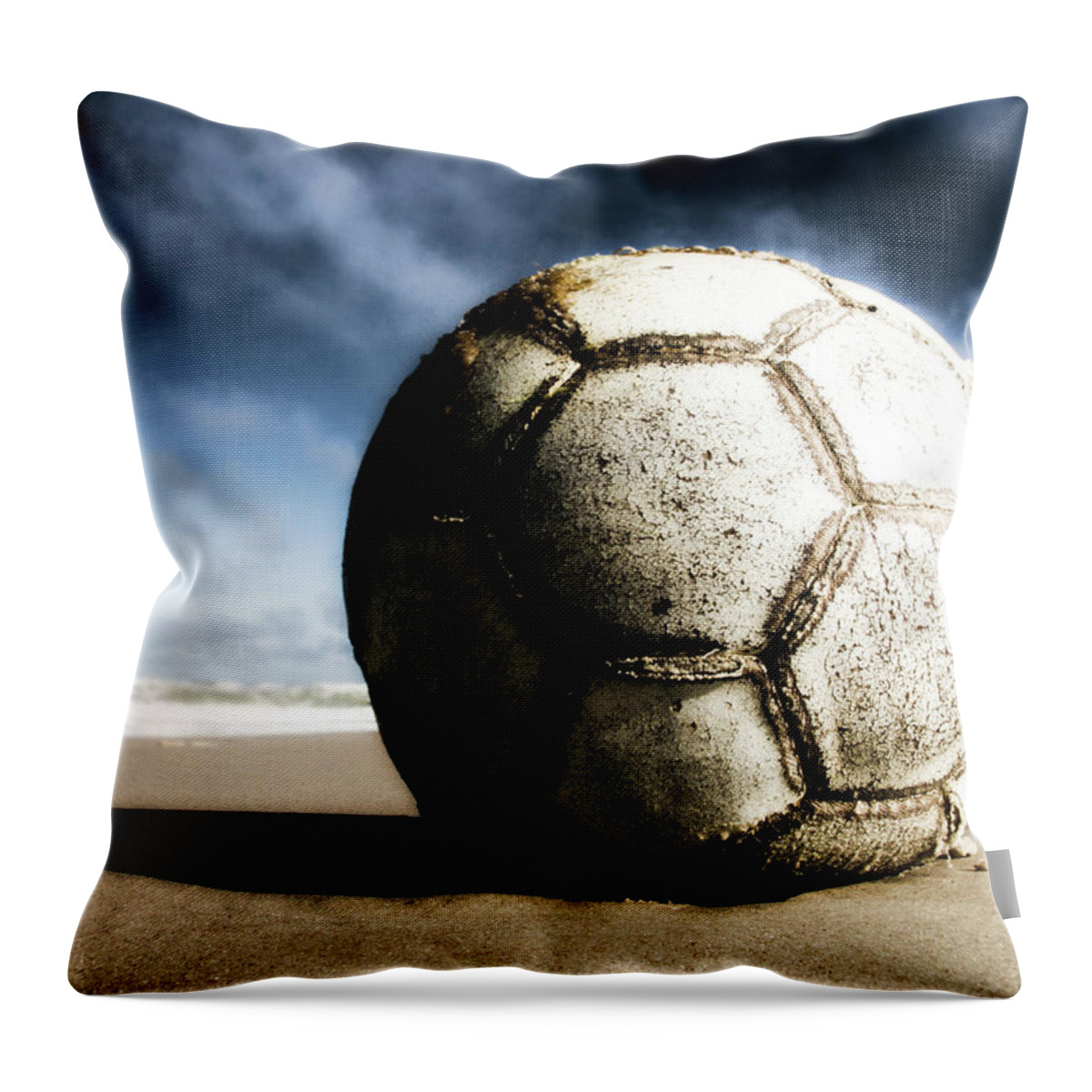 Shadow Throw Pillow featuring the photograph Worn And Old Soccer Ball On Sand by Vithib