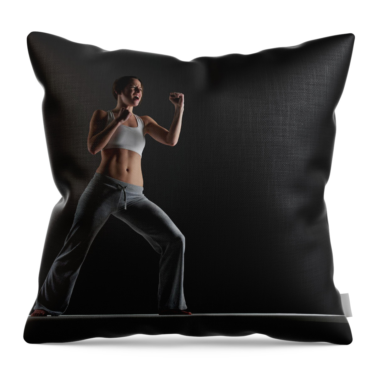 Expertise Throw Pillow featuring the photograph Young Woman Practising Karate, Close-up by John Lamb
