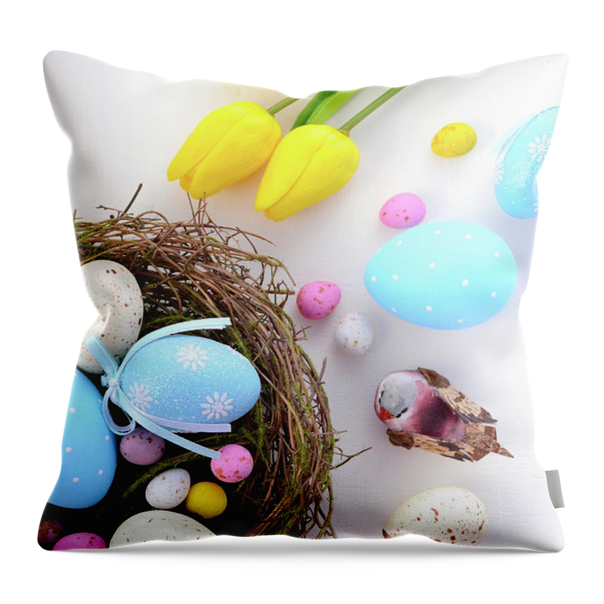 Aerial View Throw Pillow featuring the photograph Easter eggs in nest on white wood table. #1 by Milleflore Images
