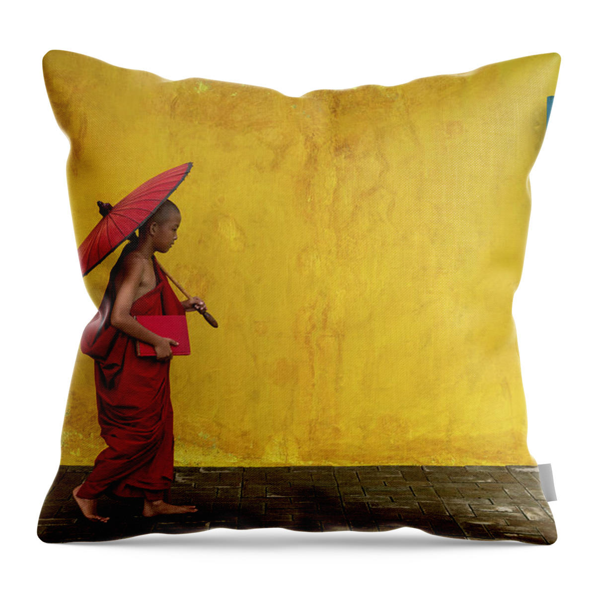 Novice Throw Pillow featuring the photograph A novice monk walking by by Anges Van der Logt