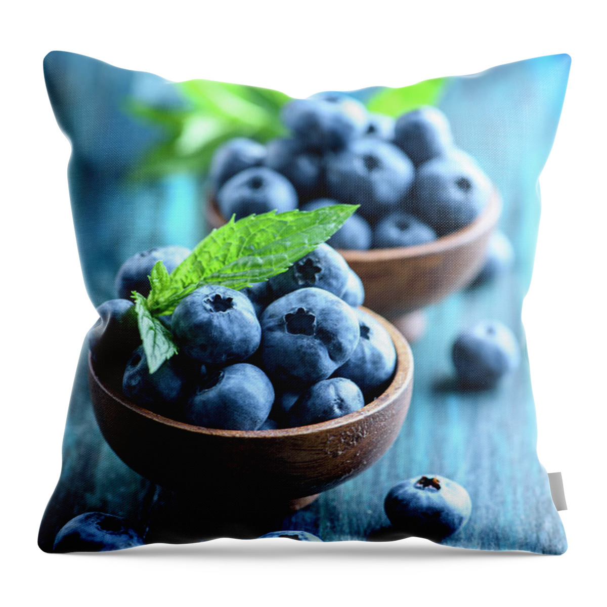 Blueberries Throw Pillow featuring the photograph Bowl of fresh blueberries on blue rustic wooden table closeup. by Jelena Jovanovic