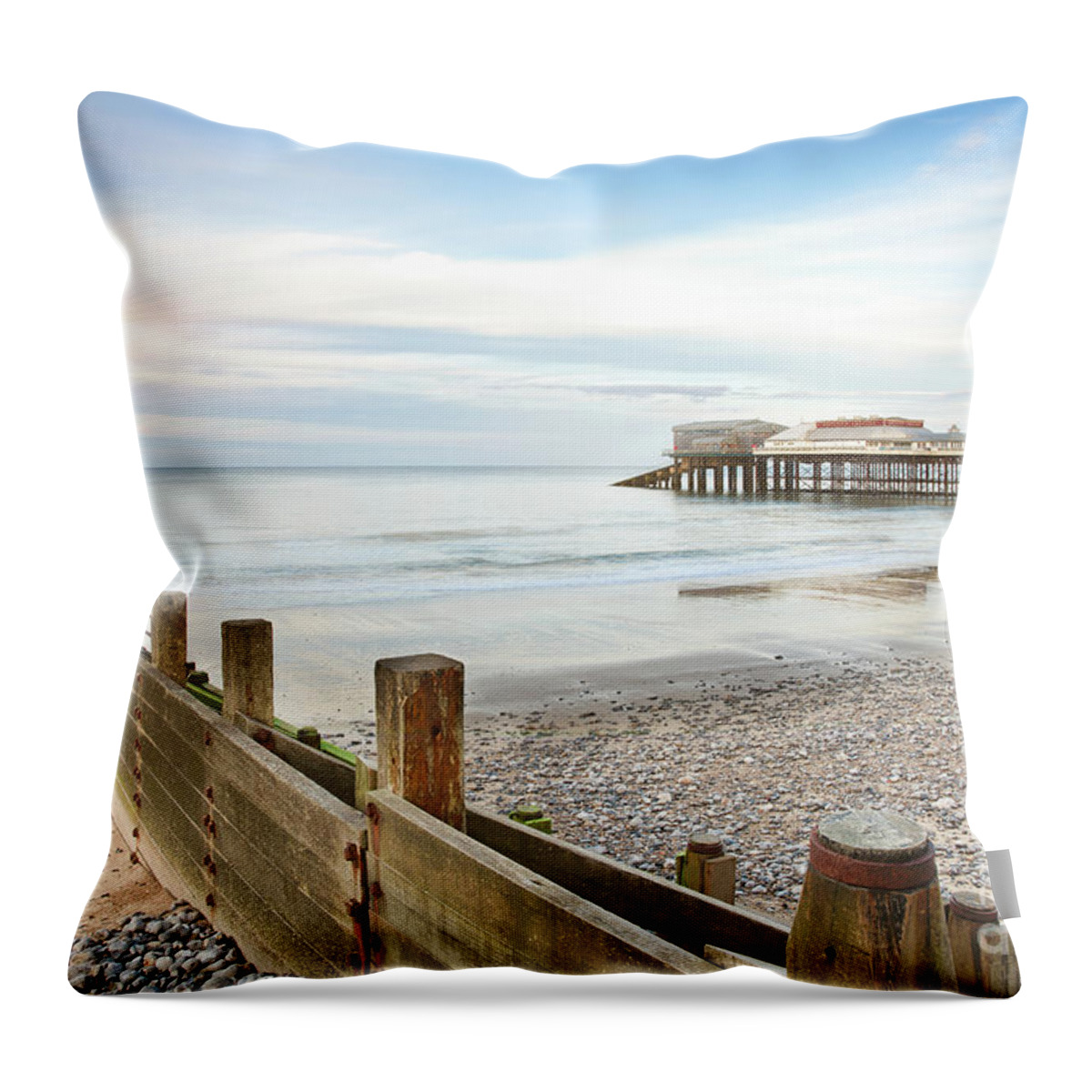 Cromer Throw Pillow featuring the photograph Cromer Pier in Norfolk England with beach groin by Simon Bratt