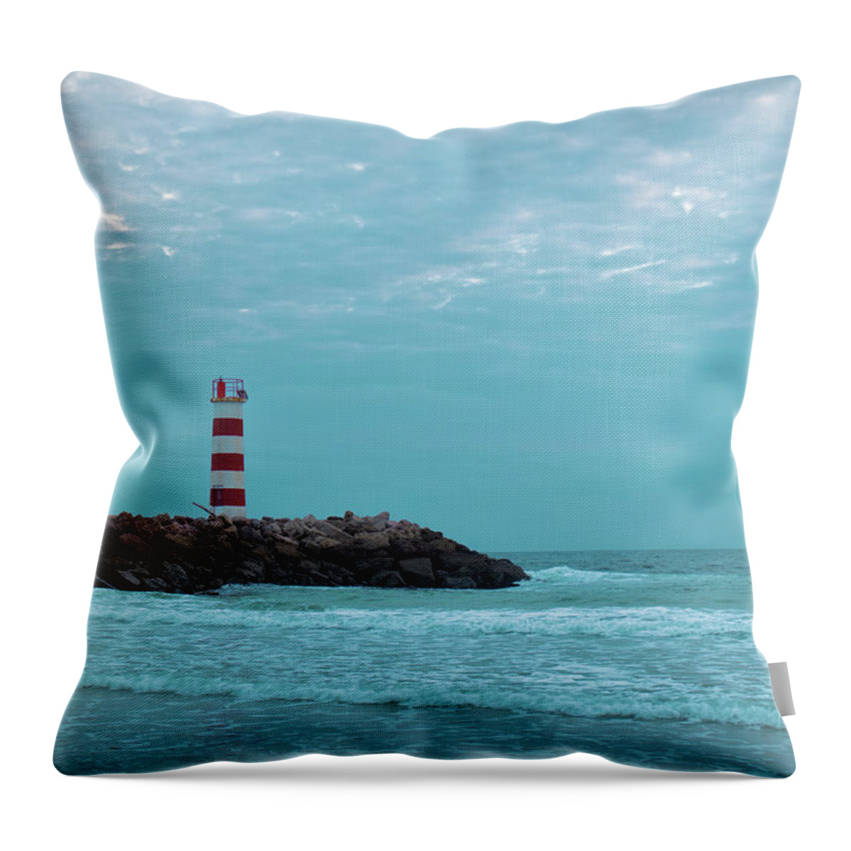 Algarve Throw Pillow featuring the photograph Light tower and rocks in Ilha Deserta, Algarve by Angelo DeVal