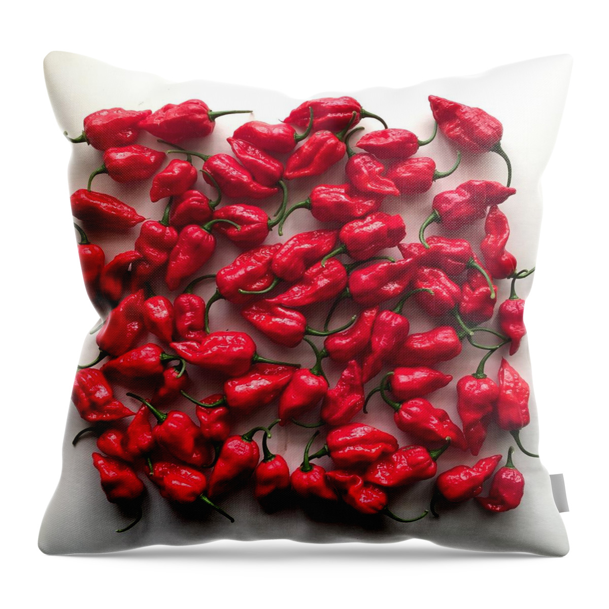 Naga Chilli Peppers Throw Pillow featuring the photograph Naga chilli peppers by Sonny Chana