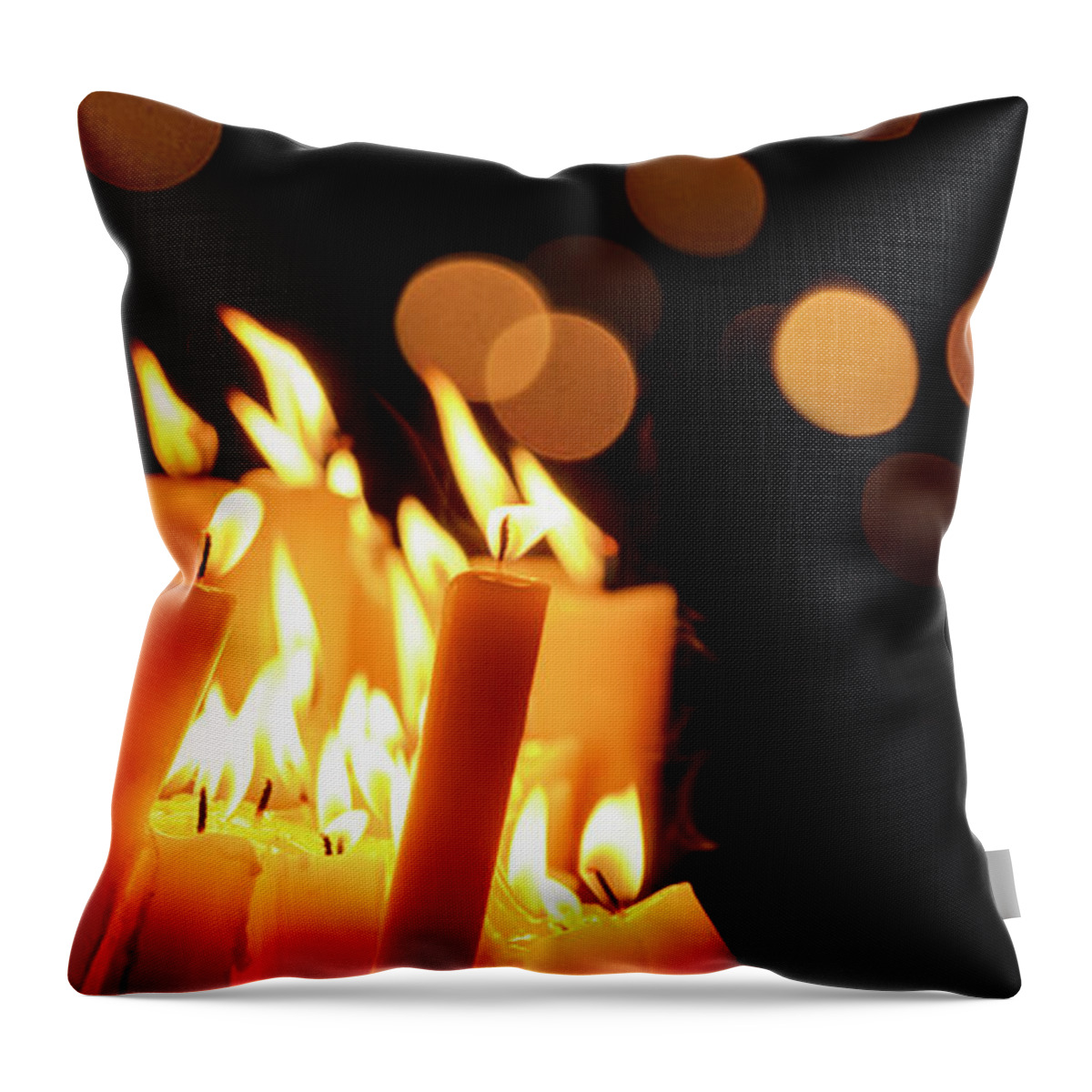 Candle Throw Pillow featuring the photograph Religious candles in front of bokeh light by Jelena Jovanovic