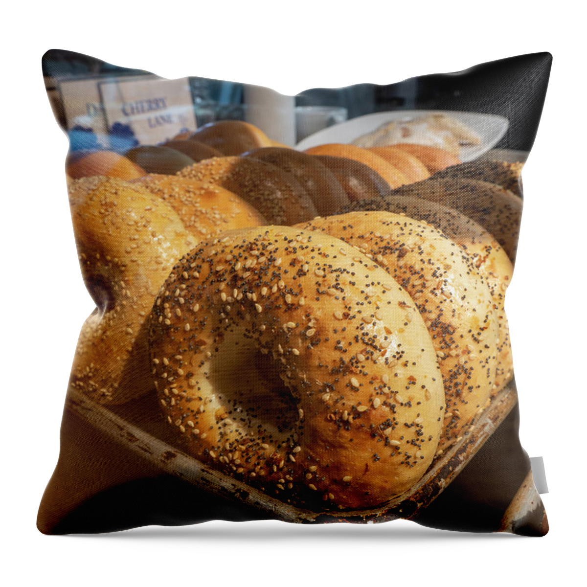 Appetizer Throw Pillow featuring the photograph Tray of bagels in a bakery. by Kyle Lee