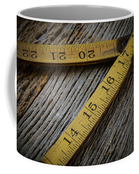Accuracy Coffee Mug featuring the photograph Old Tape Measure on Rustic Wood Background by Brandon Bourdages