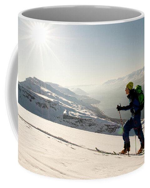 20s Coffee Mug featuring the photograph A Norwegian Skier Climbs Above Lyngen #6 by Kari Medig
