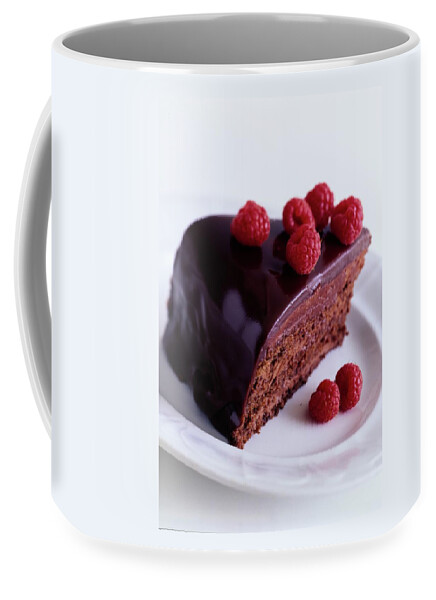 A Chocolate Pecan Cake With Raspberries On Top Coffee Mug