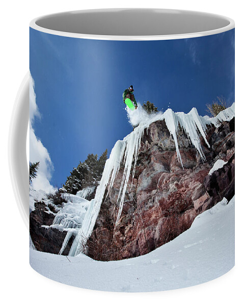 Action Coffee Mug featuring the photograph A Male Snowboarder Jumps Off An Ice by Patrick Orton