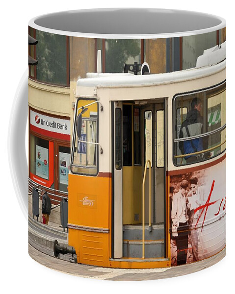 Tram Coffee Mug featuring the photograph A yellow tram on the streets of Budapest Hungary by Imran Ahmed