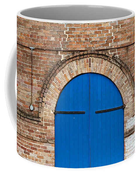 New Orleans Coffee Mug featuring the photograph Blue Door and Brick by Jarrod Erbe