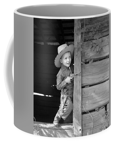 1950s Coffee Mug featuring the photograph Boy In Cowboy Outfit With Toy Gun by B. Taylor/ClassicStock