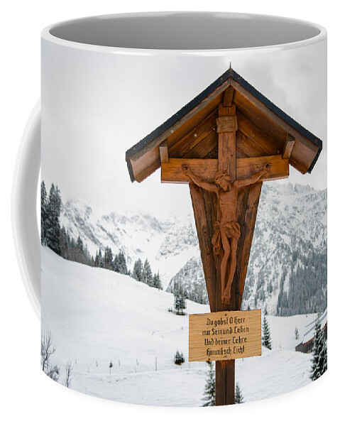 Crucifix Coffee Mug featuring the photograph Brown wayside crucifix in the mountains in winter with snow by Matthias Hauser