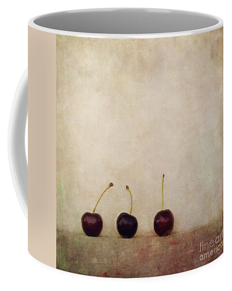 Minimalist Still Life Image With Three Cherries On A Board. Coffee Mug featuring the photograph Cherries by Priska Wettstein