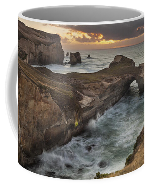 Colin Monteath Coffee Mug featuring the photograph Cliffs And Tunnel Beach Otago New by Colin Monteath
