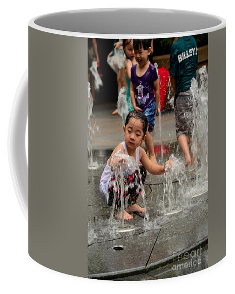 Girl Coffee Mug featuring the photograph Clothed children play at water fountain by Imran Ahmed