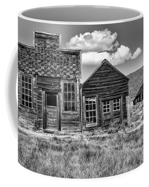 Black & White;black + White;monochrome;black And White;architecture;detail;details;cabins;structures;wood;windows;doors;door;window;buildings;dilapidated;rundown;abandoned;forlorn;derelict;empty;sandra Bronstein;clouds;doorways;entrances;old West;out West;bodie;ghost Town;ghost Towns;california;gold Rush Days;mining;houses;house;residence;horizontal;fine Art Photography;iconic;travel;tourism;historical;state Park;popular;dated;unoccupied;panes;glass;western United States;canvas; Coffee Mug featuring the photograph Days of Glory Gone by Sandra Bronstein