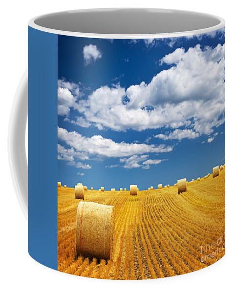 Agriculture Coffee Mug featuring the photograph Farm field with hay bales by Elena Elisseeva
