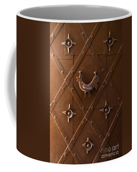Metal Coffee Mug featuring the photograph Hen shaped doorknob on a brown metal doors by Jaroslaw Blaminsky