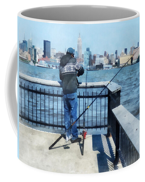 Hoboken Coffee Mug featuring the photograph Man Fishing Off Hoboken Pier by Susan Savad