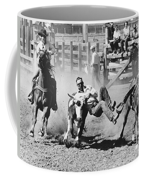 1950's Coffee Mug featuring the photograph Rodeo Cowboy Bulldogging by Underwood Archives