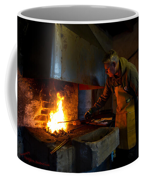 The Torresta Blacksmith Coffee Mug featuring the photograph The Torresta Blacksmith by Torbjorn Swenelius