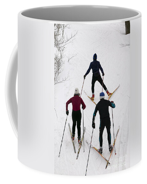 New England Coffee Mug featuring the photograph Three cross country skiers. by Don Landwehrle