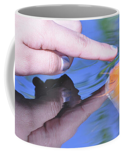Koi Coffee Mug featuring the photograph Touching the Koi. by Debby Pueschel