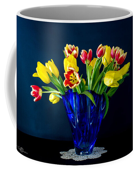 Tulips In Blue Coffee Mug featuring the photograph Tulips in Blue by Torbjorn Swenelius