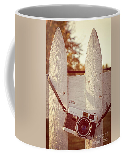 Sunrise Coffee Mug featuring the photograph Vintage film camera on picket fence by Edward Fielding