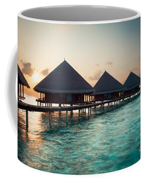 Amazing Coffee Mug featuring the photograph Waterbungalows At Sunset by Hannes Cmarits
