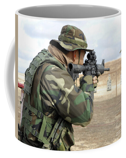 Rear View Coffee Mug featuring the photograph A Soldier Fires Rounds Down Range At An by Stocktrek Images
