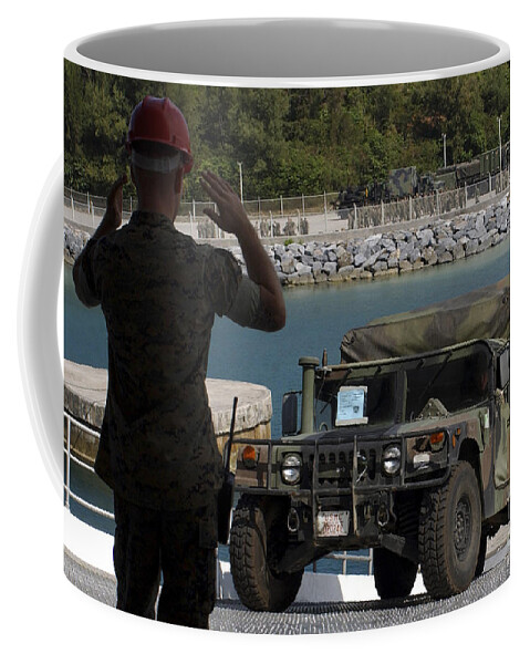 Camouflage Coffee Mug featuring the photograph A Specialist Directs A Humvee Aboard by Stocktrek Images