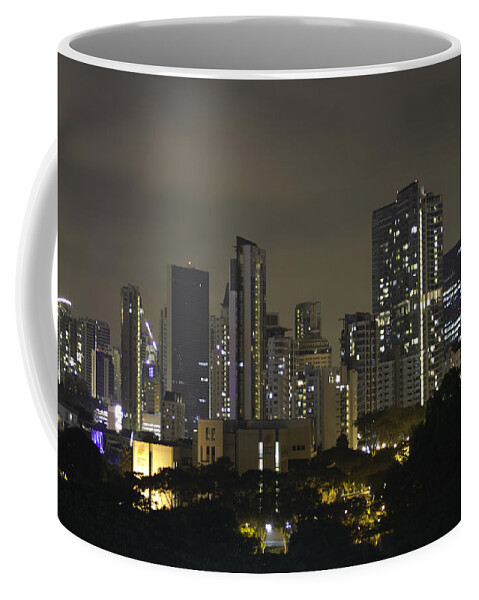 Action Coffee Mug featuring the photograph Skyline of Singapore at night as seen from an apartment complex by Ashish Agarwal