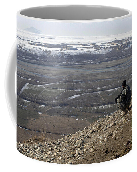 Afghanistan Coffee Mug featuring the photograph U.s. Army Soldier Looks by Stocktrek Images