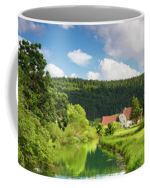 Farm Coffee Mug featuring the photograph A farm in the mountains of Jura by Paul MAURICE