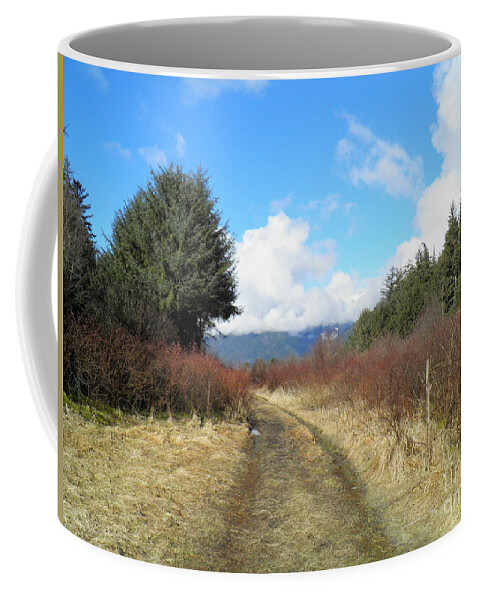 Trees Field Bushes Mountains Clouds Sky Trail Brush Grass Puddle Blue Green Yellow White Light Shadow Dark Bright Brown Coffee Mug featuring the painting A long walk by Ida Eriksen