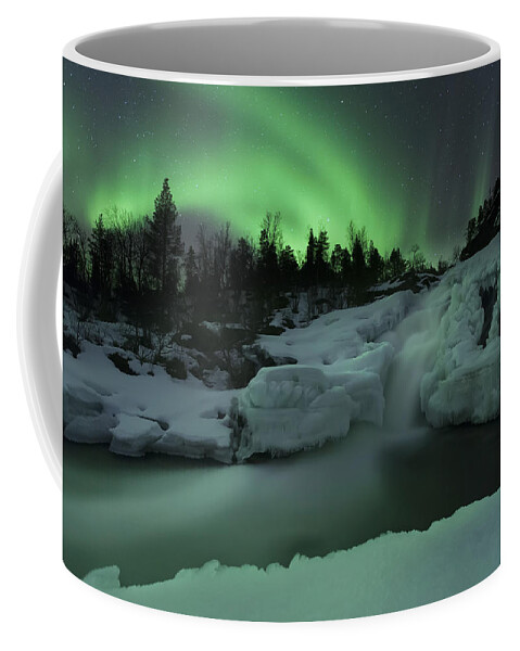 Green Coffee Mug featuring the photograph A Wintery Waterfall And Aurora Borealis by Arild Heitmann