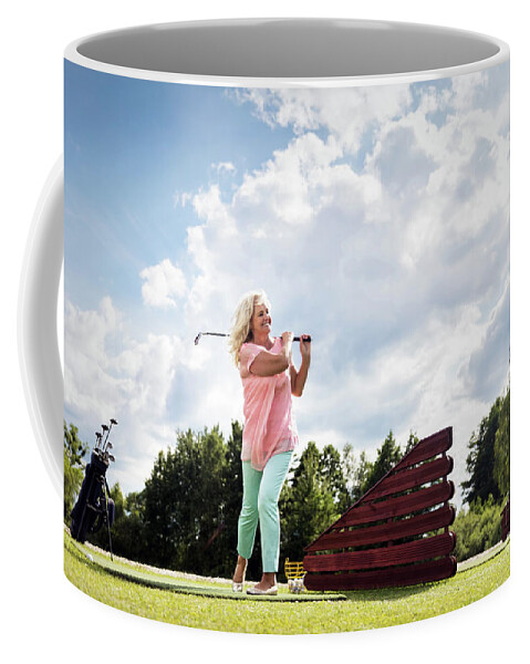 Senior Coffee Mug featuring the photograph Active senior woman playing golf. by Michal Bednarek