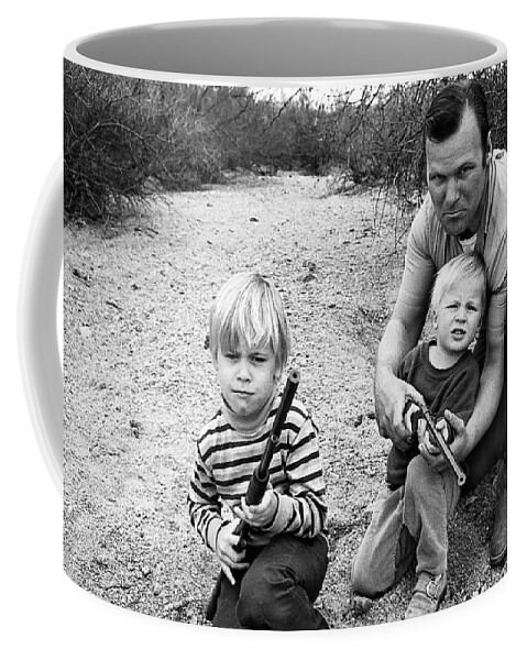 Barry Sadler Instructing Sons Shooting With Toy Rifles Tucson Arizona 1971 Coffee Mug featuring the photograph Barry Sadler instructing sons shooting with toy rifles Tucson Arizona 1971 by David Lee Guss