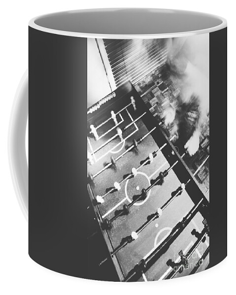 Black And White Coffee Mug featuring the photograph Blurred man playing an indoor foosball by Jorgo Photography