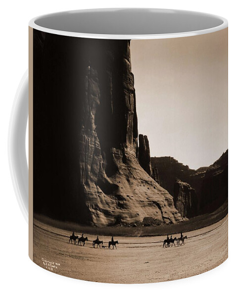 Indian Coffee Mug featuring the painting Canyon de Chelly Navajo. Seven riders on horseback. Edward S. Curtis. USA, 1900 by Celestial Images