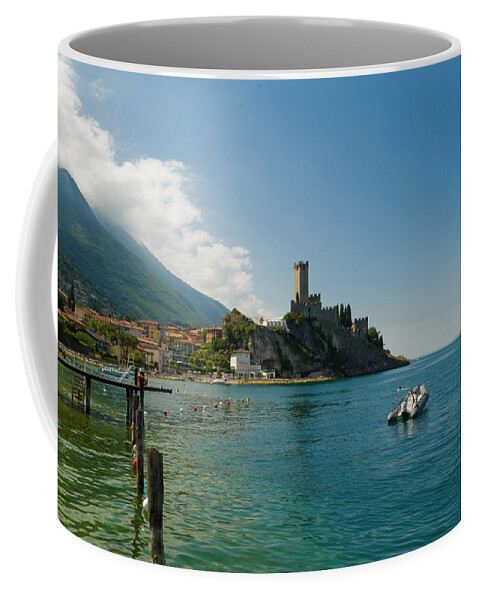 Lake Coffee Mug featuring the photograph Castle of Malcesine, view from the beach by Nicola Aristolao