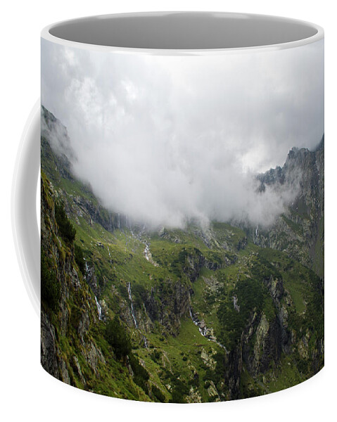 Mountain Coffee Mug featuring the photograph Clouds on the top of the mountain by Nicola Aristolao