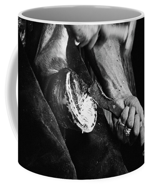 Horse Coffee Mug featuring the photograph Farrier at work on horses hoof by Dimitar Hristov
