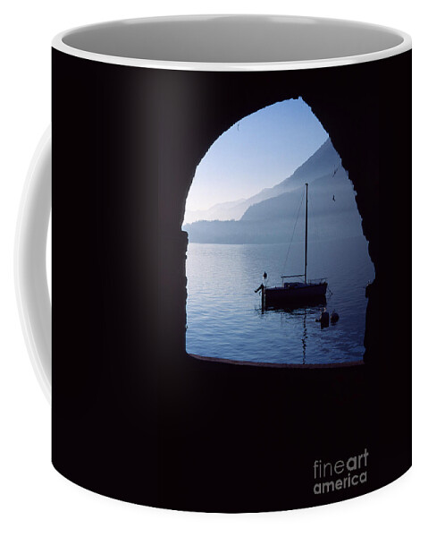 Varenna Coffee Mug featuring the photograph Framed blue lake by Riccardo Mottola